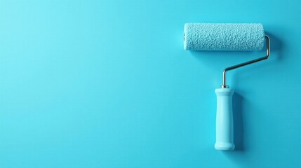 Obraz premium A Light Blue Paint Roller Against a Matching Background Ready for a Fresh Coat