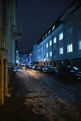 city, evening, the street is lit by lanterns and cars	