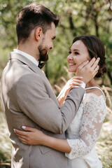 Fototapeta premium guy and a girl newlyweds are walking in the forest