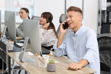 Sales department. People calling to clients in office, selective focus