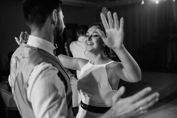 the first dance of the bride and groom inside a restaurant
