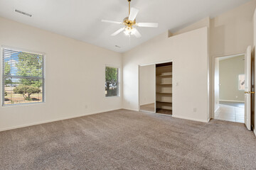 Spacious living room with wooden flooring and sliding doors leading to a bright outdoor area