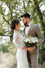 guy and a girl newlyweds are walking in the forest