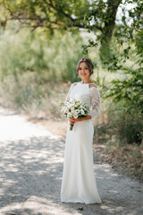young girl in a beautiful tight dress with a bouquet