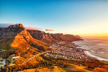 Cape Town Sunset over Camps Bay Beach with Table Mountain and Twelve Apostles in the Background