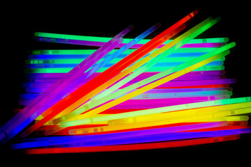Colorful party glow sticks on black background