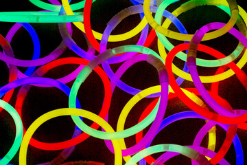 Chemical glow circles in rainbow colors on a black background