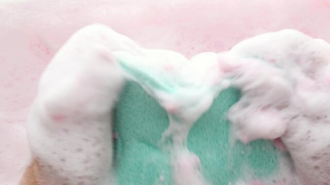 Hands in fluffy foam slowly squeeze the washcloth. Soothing visual effect Asmr. View from above Part 4