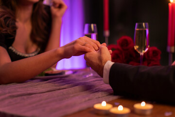 Marriage proposal. Guy holding female hand, lady wearing engagement ring after couple making decision to get married, closeup shot
