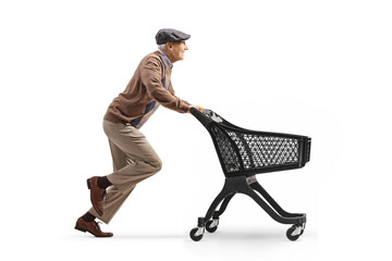 Full length profile shot of a pensioner running with an empty shopping cart