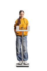 Teenage girl measuring on a medical weight scale
