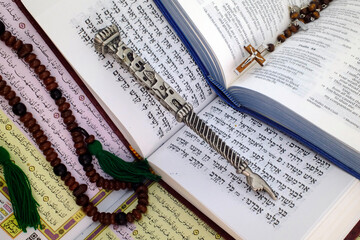 Bible, Quran and Torah. Concept of interfaith dialogue.  Christianity, Islam and Judaism, the three...