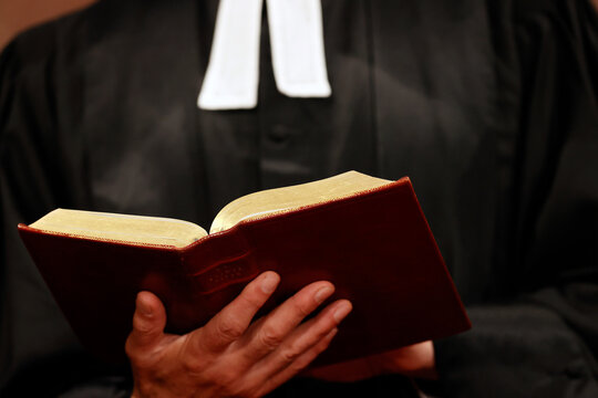 Sunday service in a Protestant church. Pastor reading the Bible.  Paris. France.