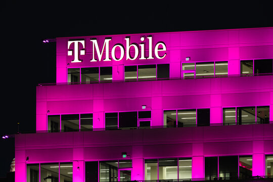 Bellevue, WA, USA - January 14, 2025; Magenta brand color illuminating T-Mobile corporate office with sign