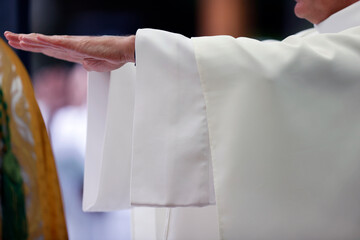 Catholic mass. Lord's Prayer. Priest praying. Close-up on hands.  La Roche sur Foron..  France.