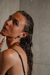 The close-up shot emphasizes natural elegance and calm confidence. A woman with wet hair poses...