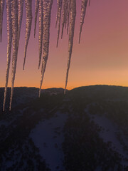 Icicles Framed Against a Vibrant Sunset Sky