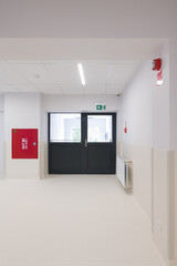 Modern Hallway with Double Doors and Fire Safety Elements