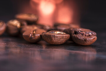 Fototapeta premium Freshly roasted coffee beans on a metallic surface, close-up view