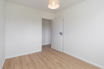 Empty Room with Open Doorway and Wooden Floor