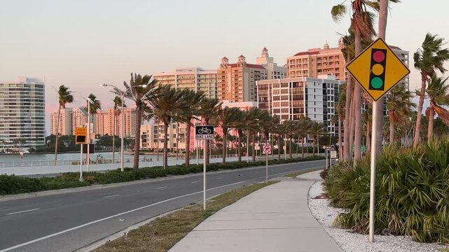 Downtown Sarasota Florida with Golden Gate Point from John Ringling Causeway bridge, yachts, palms and hotels, pink skies during beautiful Florida sunset