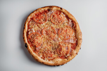 pizza with tomatoes and ham on white background