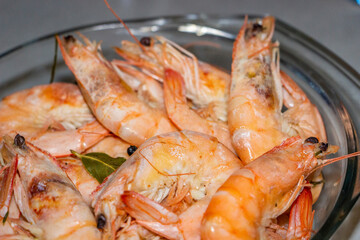 large king prawns, verine, pink, bent tails, macro, bay leaf, in a clear glass pan, seafood, food, delicious, dish