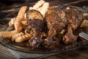 Fried chicken drumsticks with chips.