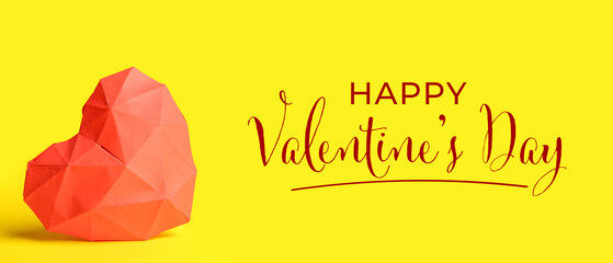 Red heart made of paper on yellow background. Valentine's Day celebration