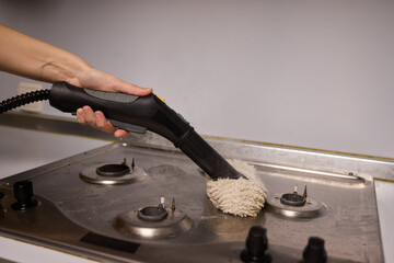 Performing a Deep Cleaning of Kitchen Equipment Using a Steam Cleaner for Hygiene and Safety
