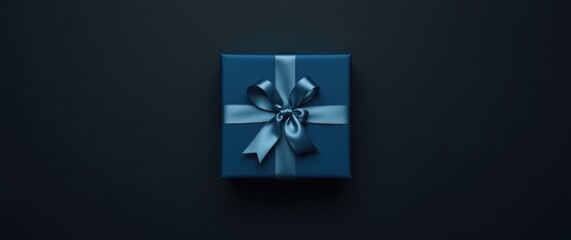 A navy blue gift box with a satin ribbon sits on a dark background.  Perfect for holidays or special occasions.