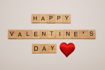 The inscription “Valentine's Day” is made of small wooden squares and a red heart at the end.