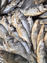 Dried fish in a busy market with a variety of fish varieties on offer