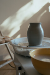 working place of potter. tools for making ceramic and just formed wed clay vase