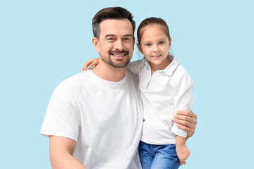 Obraz premium Father and his little daughter on blue background. Father's Day celebration