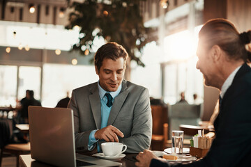 Business professionals having a meeting over coffee in a modern cafe