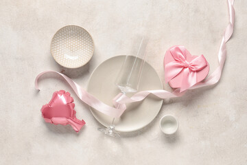 Beautiful table setting with air balloon in shape of heart and gift box on white background. Valentine's Day celebration