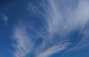 A gorgeous blue sky background with wispy white clouds. 