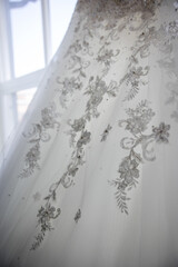 Close-up of elegant white wedding dress stitching