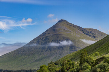 Fototapeta premium Ben Dorain with wispy low clouds and blue sky, West Highland Way, A82, Scotland