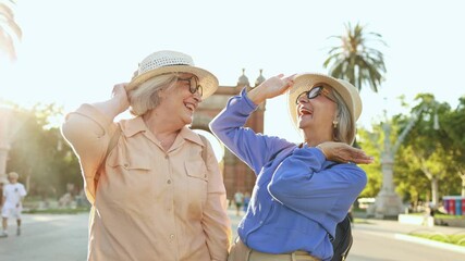 Senior women friends enjoying vacation in barcelona