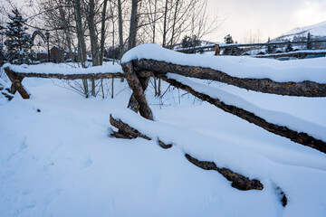winter landscape with snow covered log fence
