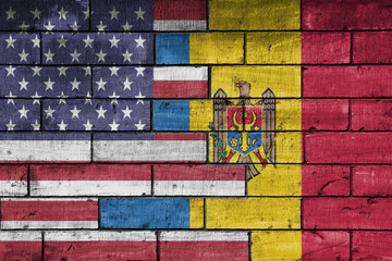 colourful painted big flag of united states of america and flag of moldova on a massive old brick...