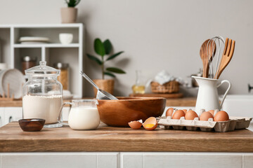 Utensils and ingredients for preparing dough on kitchen counter