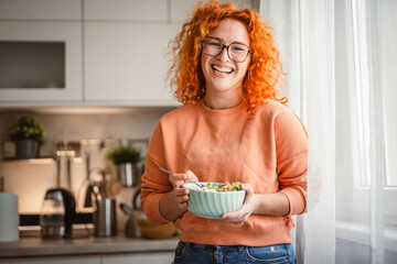 portrait of beautiful healthy woman eat salad at kitchen in the morning