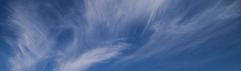 A gorgeous blue sky background with wispy white clouds. 