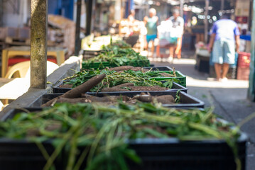 Green leaves for sale at a stand.