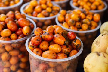 Seriguelas for sale at a market. Fruit source of fiber rich in vitamin C, flavonoids and carotenoids.