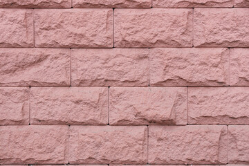 Texture of pink brick wall as background, closeup