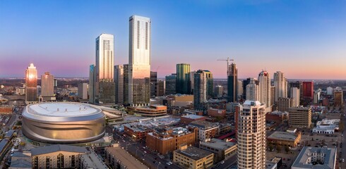 Edmonton skyline at twilight, showcasing Rogers Place arena and modern high-rises. Urban...